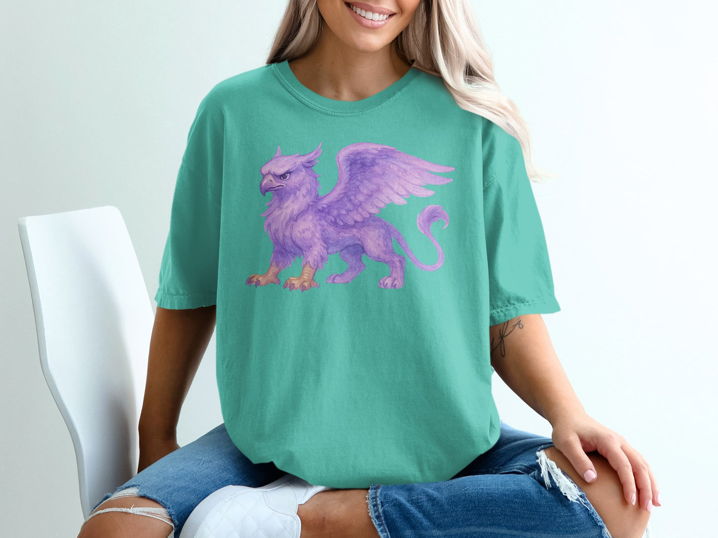 Teal t-shirt with a purple griffin graphic.