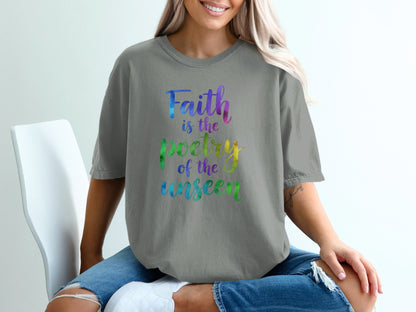 Grey t-shirt with "Faith is the poetry of the unseen" in rainbow watercolor text.