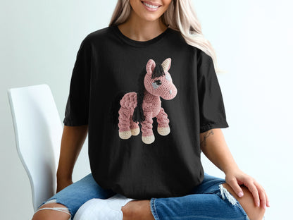 Black t-shirt with a pink crochet unicorn graphic on the front.
