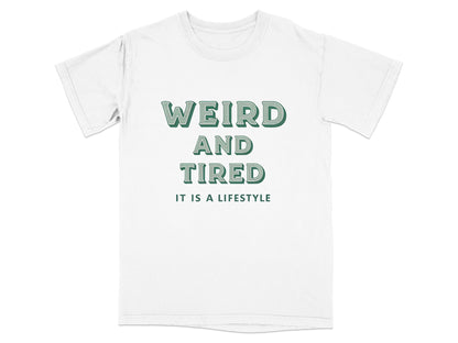 White t-shirt with "WEIRD AND TIRED IT IS A LIFESTYLE" text.