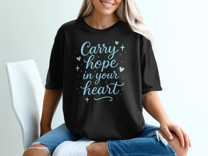 Black t-shirt with "Carry hope in your heart" text and blue sparkles.