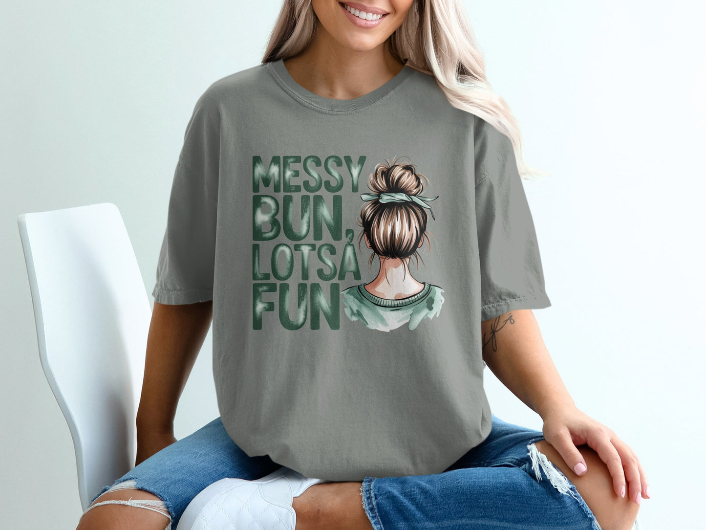 Grey t-shirt with "Messy Bun, Lotsa Fun" text and illustration of woman's head.