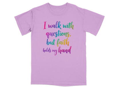 Purple t-shirt with colorful text "I walk with questions, but faith holds my hand".