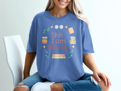 T-shirt with "Shh... I Am Reading" text and stack of books.