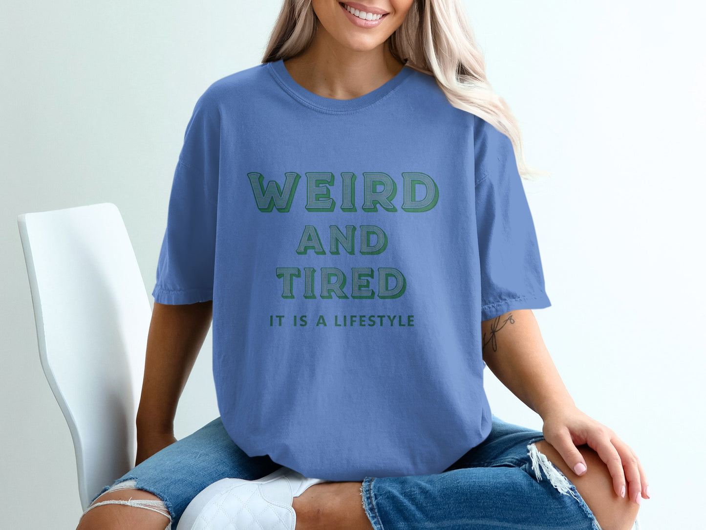 Blue t-shirt with "Weird and Tired" text and "It is a lifestyle" below.