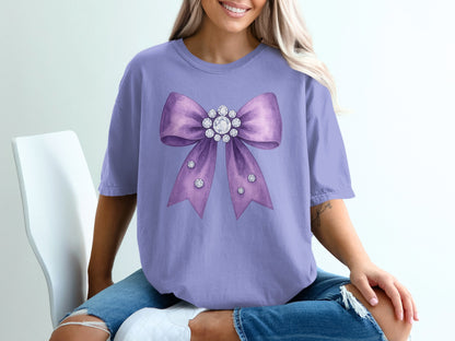 Purple t-shirt with a large sparkly bow graphic.