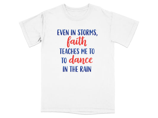 White t-shirt with blue and red text: "Even in storms, faith teaches me to dance in the rain."