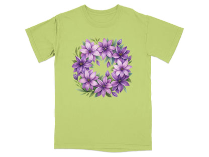 Green t-shirt with a circular floral design of purple and pink flowers.