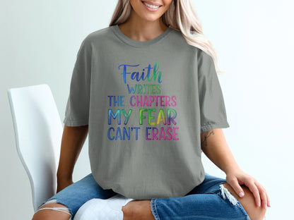 Gray t-shirt with "Faith writes the chapters my fear can't erase" text.