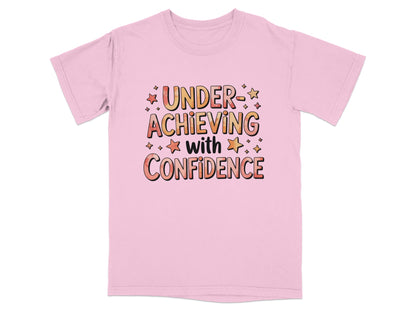 Pink t-shirt with "UNDER ACHIEVING WITH CONFIDENCE" text and star graphics.