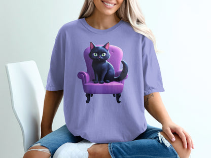 Black cat with green eyes sitting in a purple armchair.