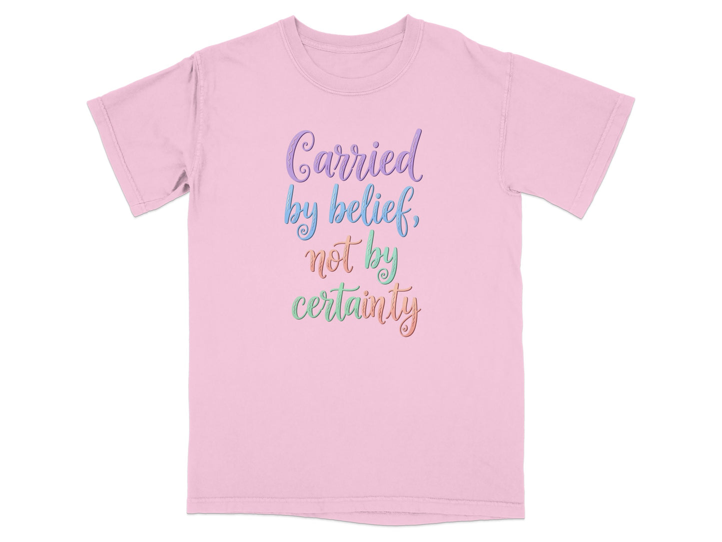Pink t-shirt with "Carried by belief, not by certainty" in colorful script.