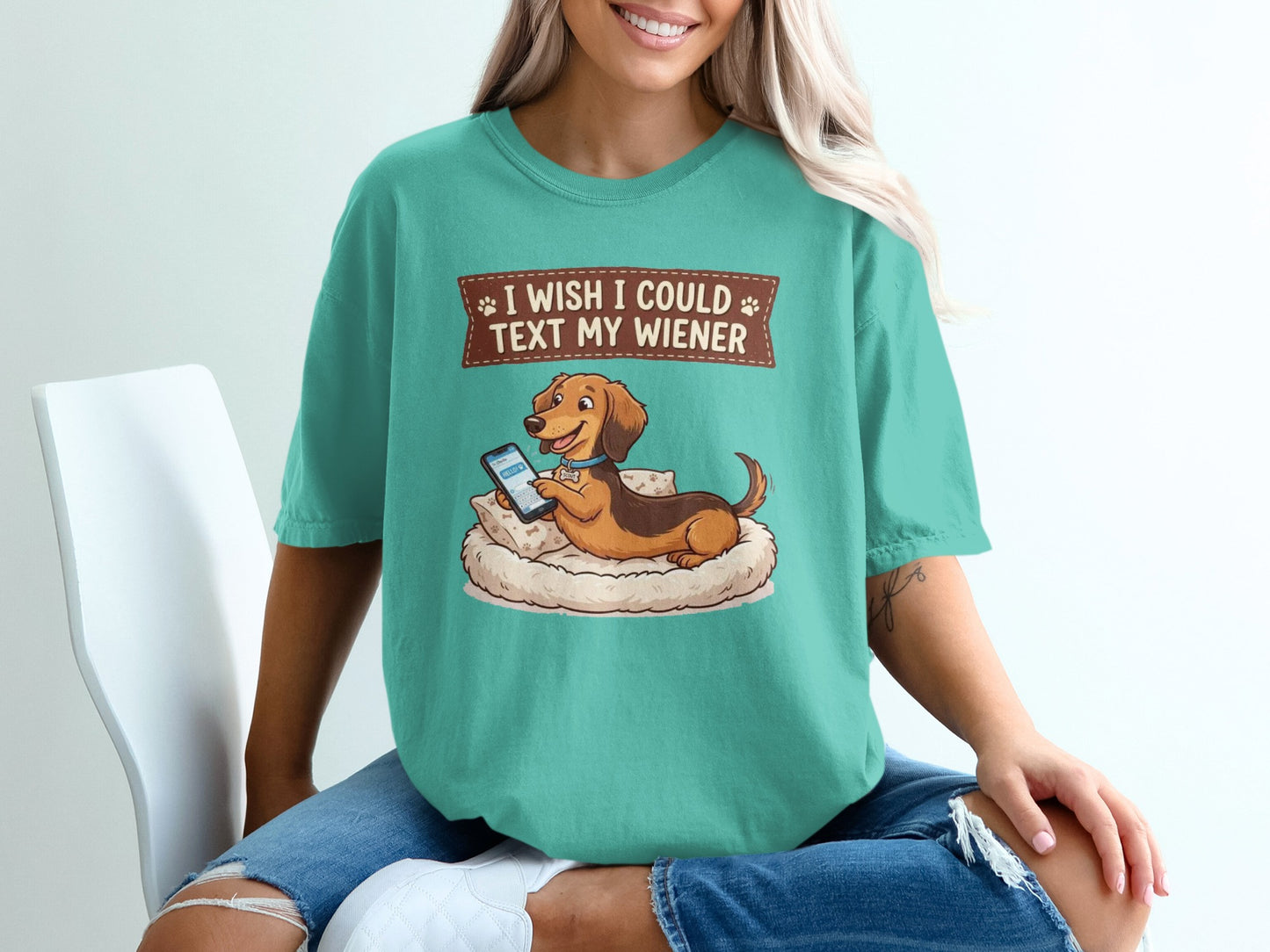 Teal t-shirt with dachshund on pillow texting, "I wish I could text my wiener."