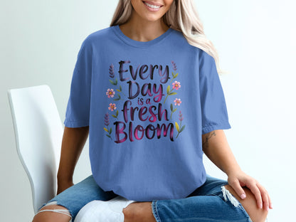 Blue t-shirt with "Every Day is a fresh Bloom" text and floral accents.
