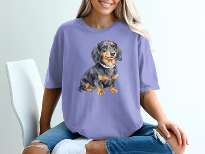Dachshund wearing a heart-shaped tag sits on a purple t-shirt.