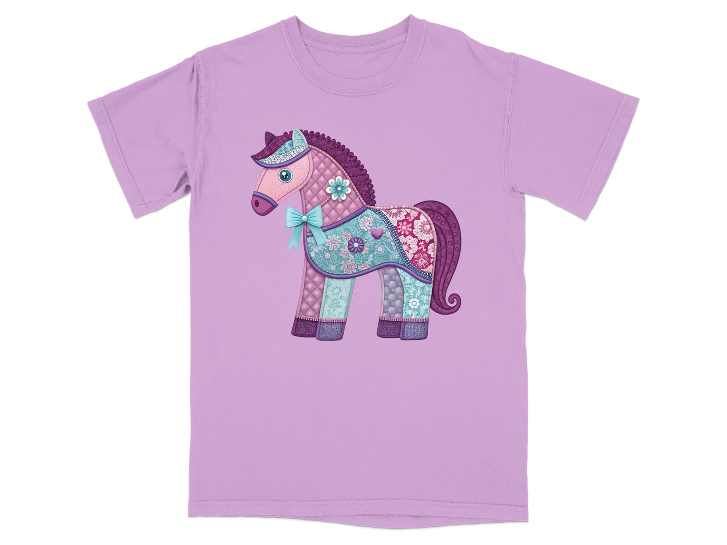 Lavender t-shirt with a quilted unicorn design featuring a blue bow.