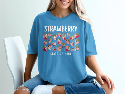 Blue t-shirt with colorful patchwork strawberries and "Strawberry State of Mind" text.