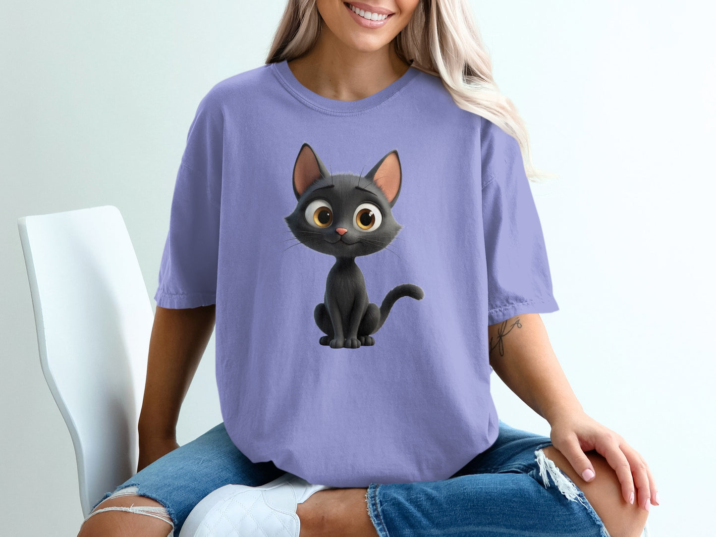 Purple t-shirt with a cartoon black cat illustration.