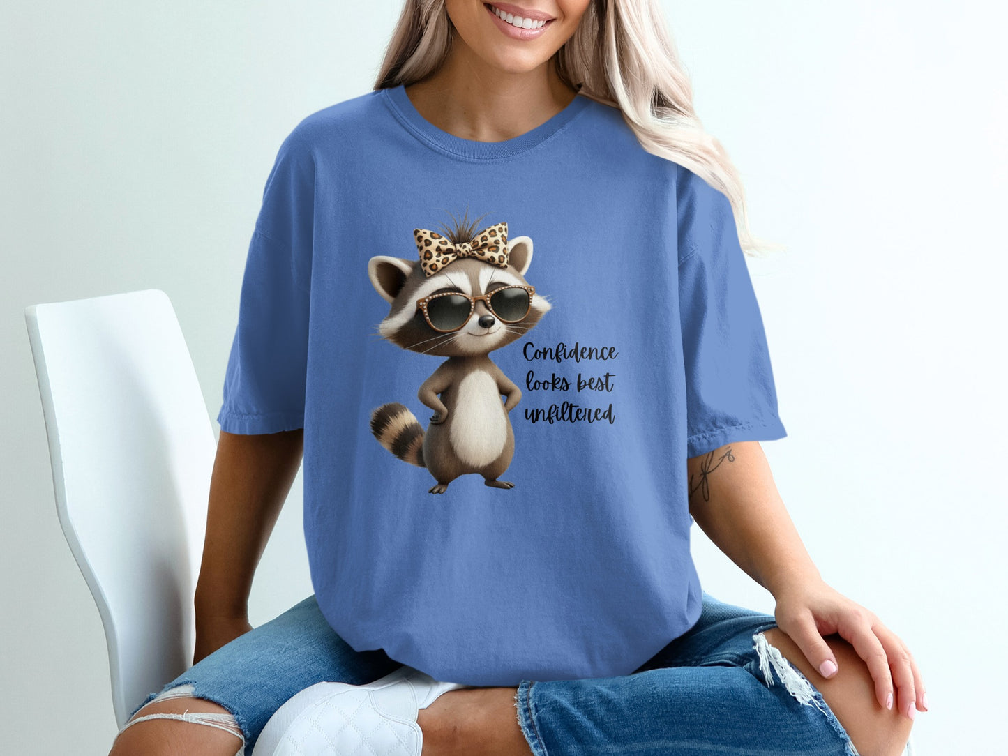 T-shirt with cartoon raccoon wearing sunglasses and a leopard print bow.