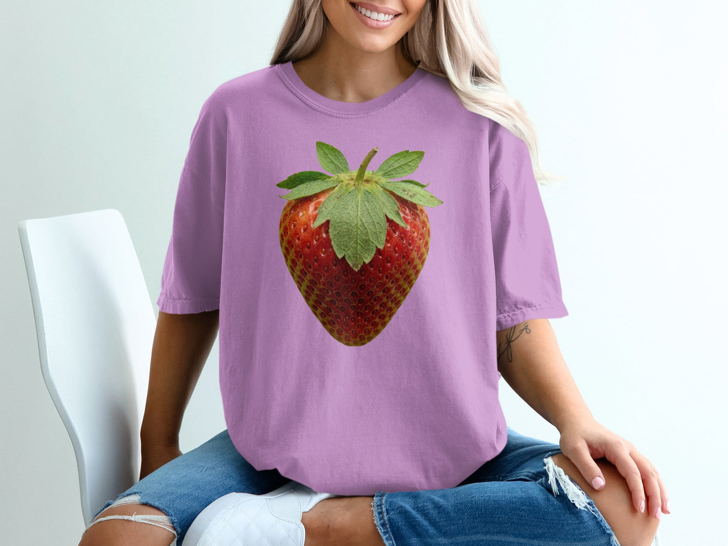 Purple t-shirt with a realistic strawberry graphic.