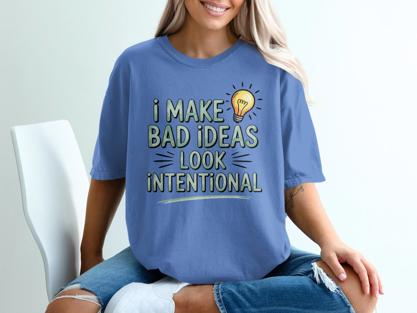 Blue t-shirt with "I make bad ideas look intentional" text and lightbulb graphic.