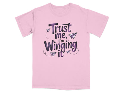 Pink t-shirt with "Trust me, I'm Winging It" in purple and black text.