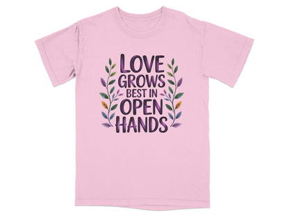 Pink t-shirt with "Love Grows Best in Open Hands" text and floral design.