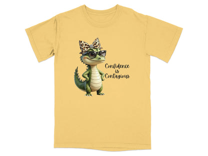Yellow t-shirt with a cartoon dinosaur wearing sunglasses and bow.