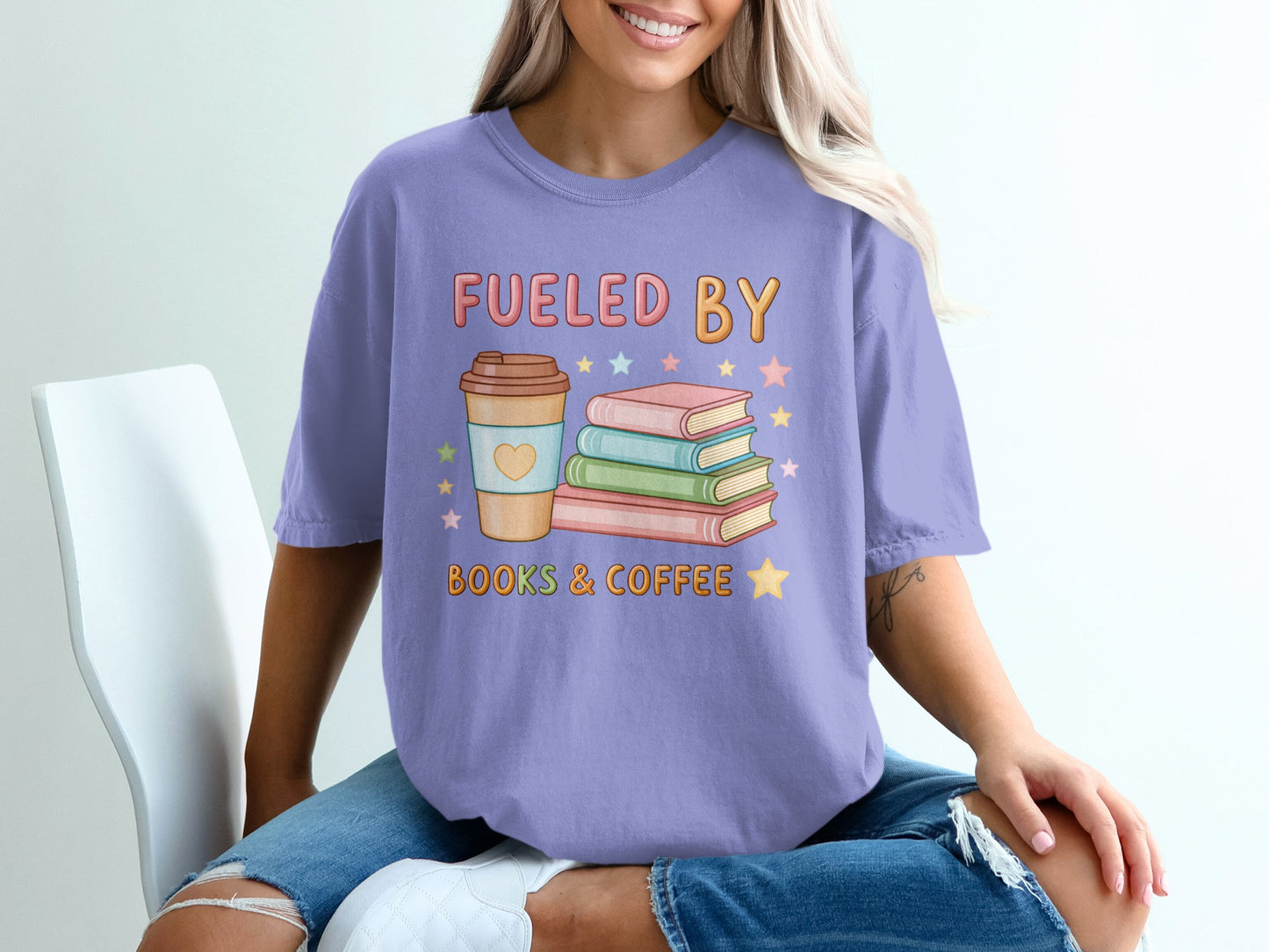Purple t-shirt with "Fueled by Books & Coffee" text and stacked books.