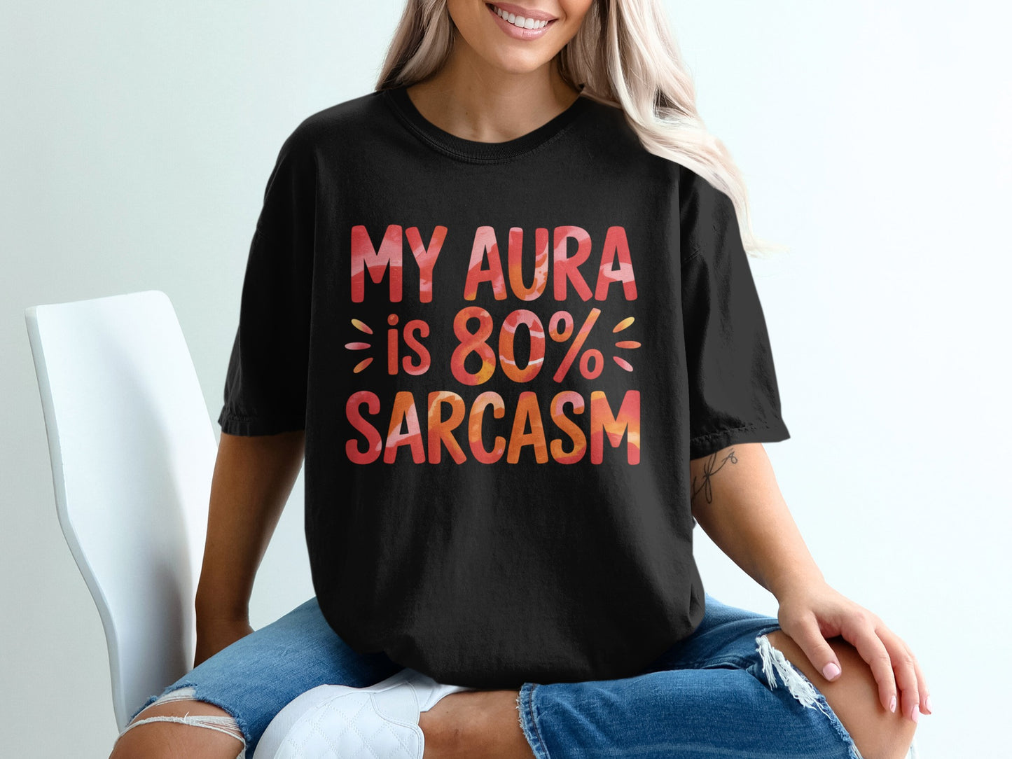 Black t-shirt with "MY AURA IS 80% SARCAST" graphic.