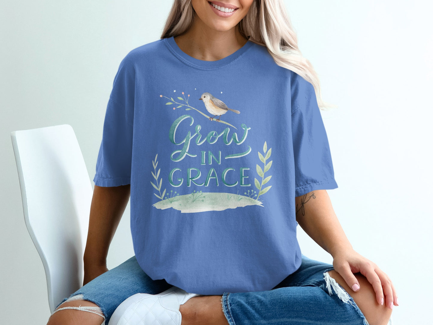 Blue t-shirt with "Grow in Grace" text and bird on branch.