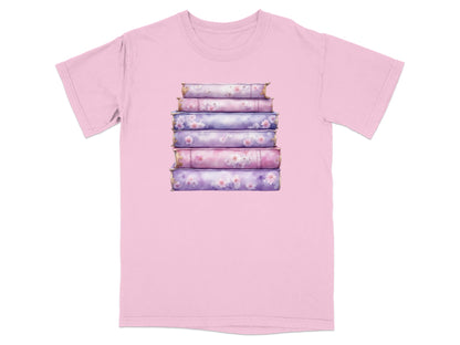 Stack of five fantasy books with floral details, printed on a pink t-shirt.