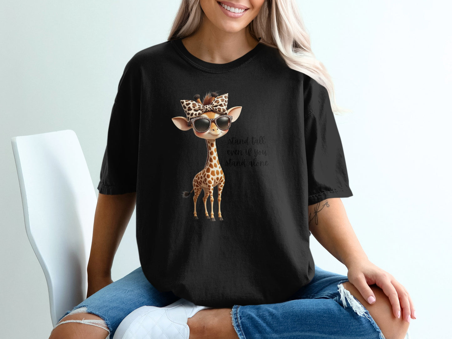 Black t-shirt with a graphic of a giraffe wearing sunglasses and a bandana.