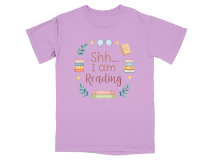 Purple t-shirt with "Shh... I am Reading" text and stacked books graphic.