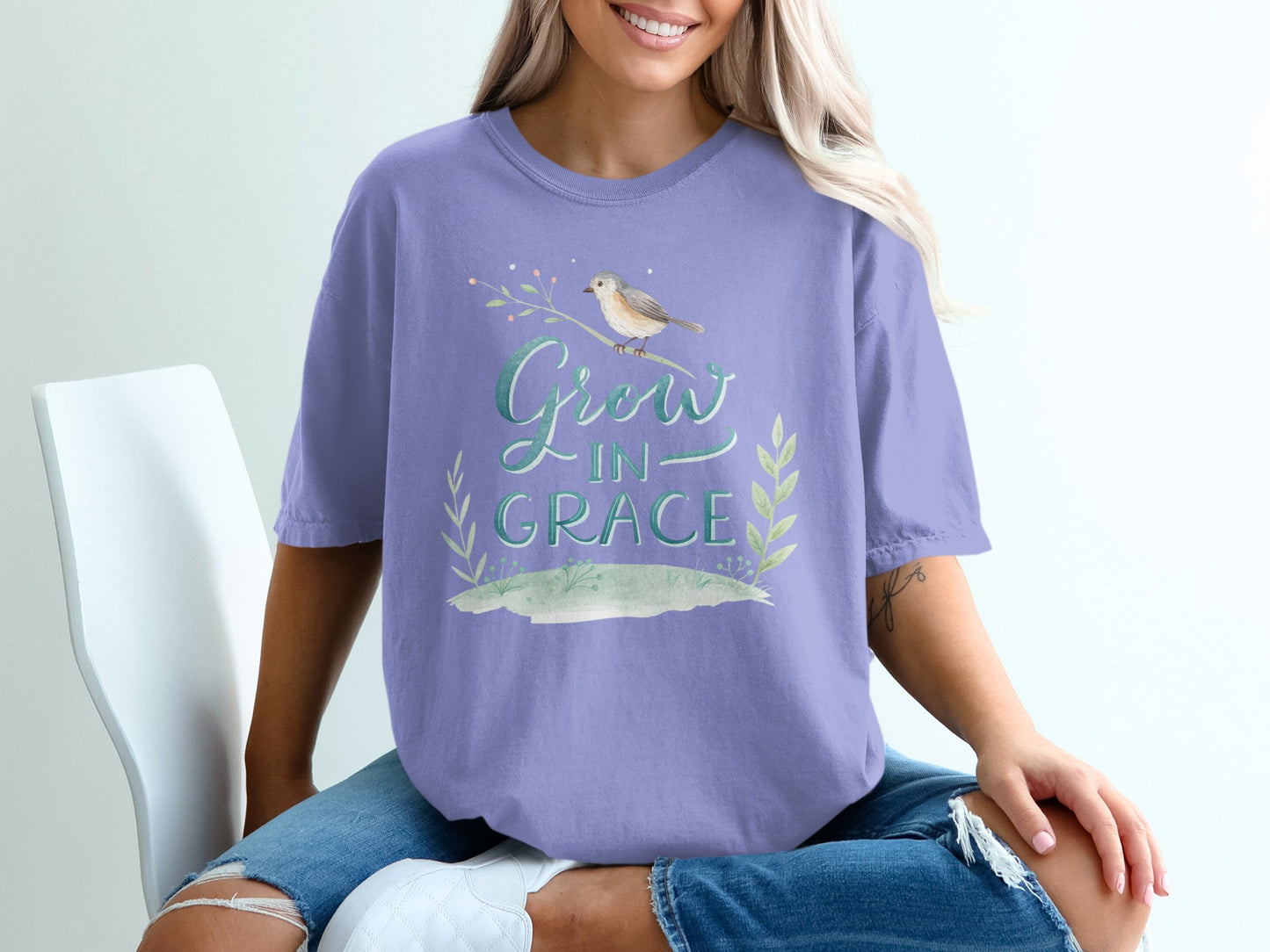 Purple t-shirt with "Grow in Grace" text and bird design.