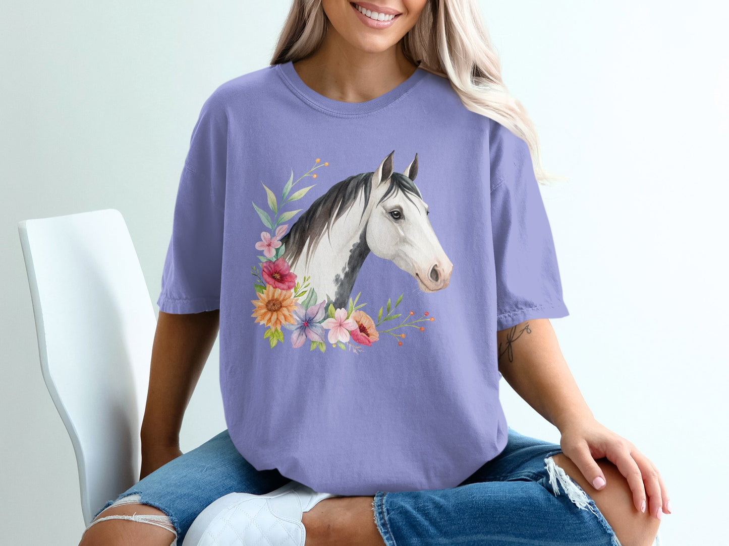 Purple t-shirt with watercolor horse head and floral accents.