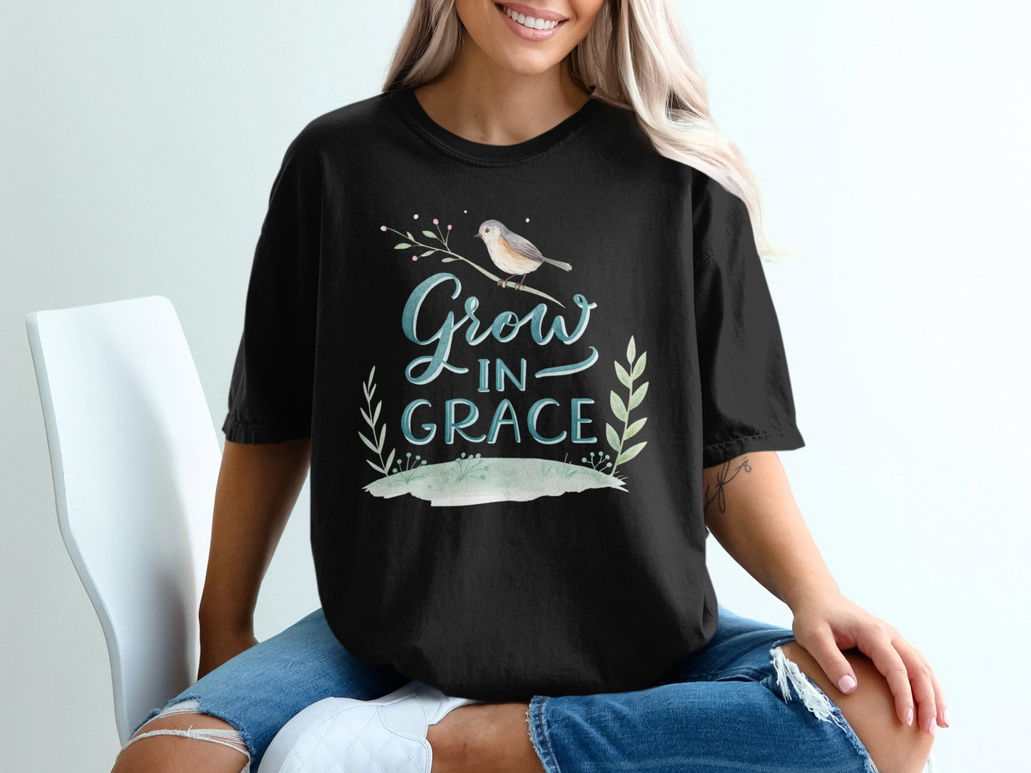 Black t-shirt with "Grow in Grace" text and bird on a branch.