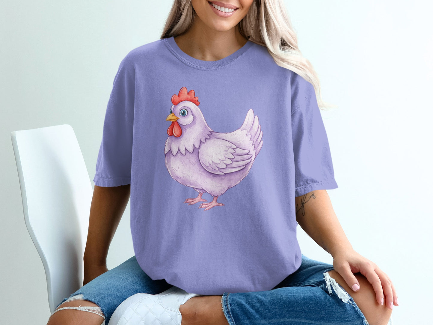 Purple t-shirt with a watercolor illustration of a white chicken.