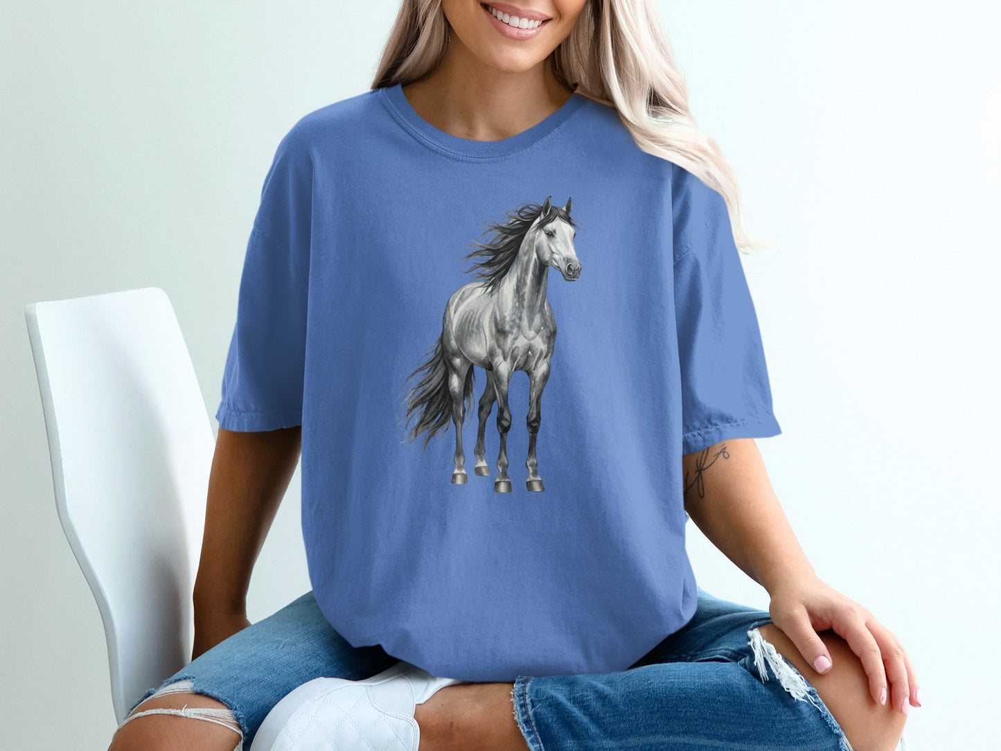Blue t-shirt with a graphic of a gray horse in motion.