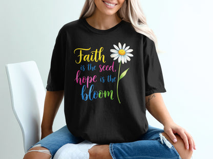 Black t-shirt with colorful text "Faith is the seed, hope is the bloom" and a daisy.