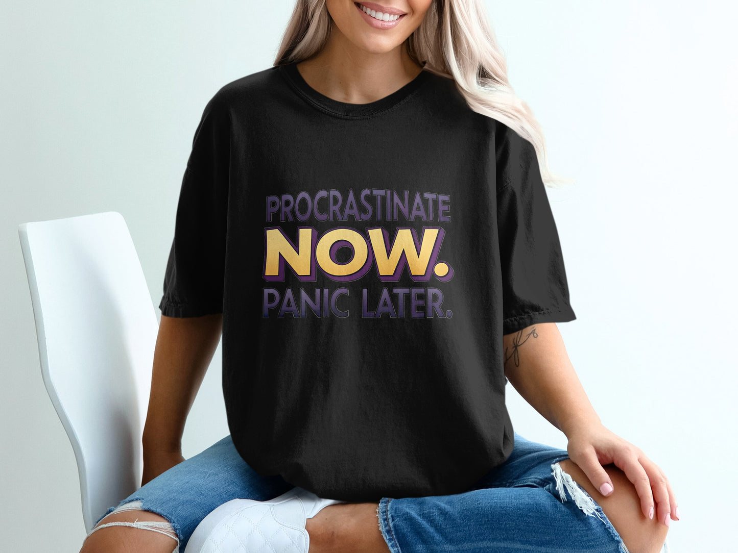 Black t-shirt with "PROCRASTINATE NOW. PANIC LATER." text.