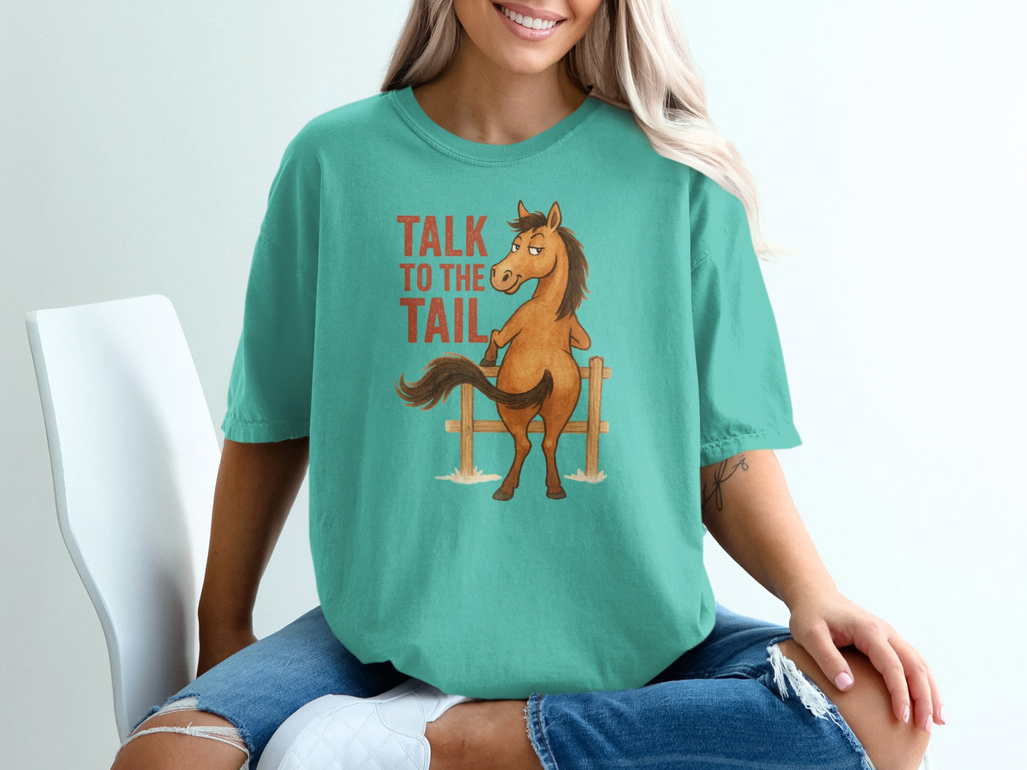 Teal t-shirt with a cartoon horse and "Talk to the Tail" text.