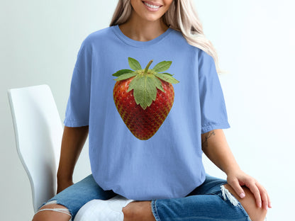 Blue t-shirt with a large strawberry graphic on the chest.