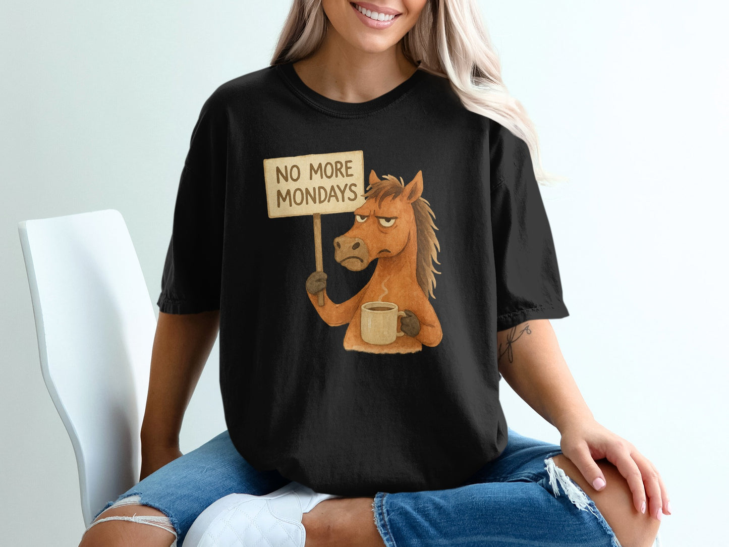 Black t-shirt with distressed horse holding "NO MORE MONDAYS" sign and coffee.