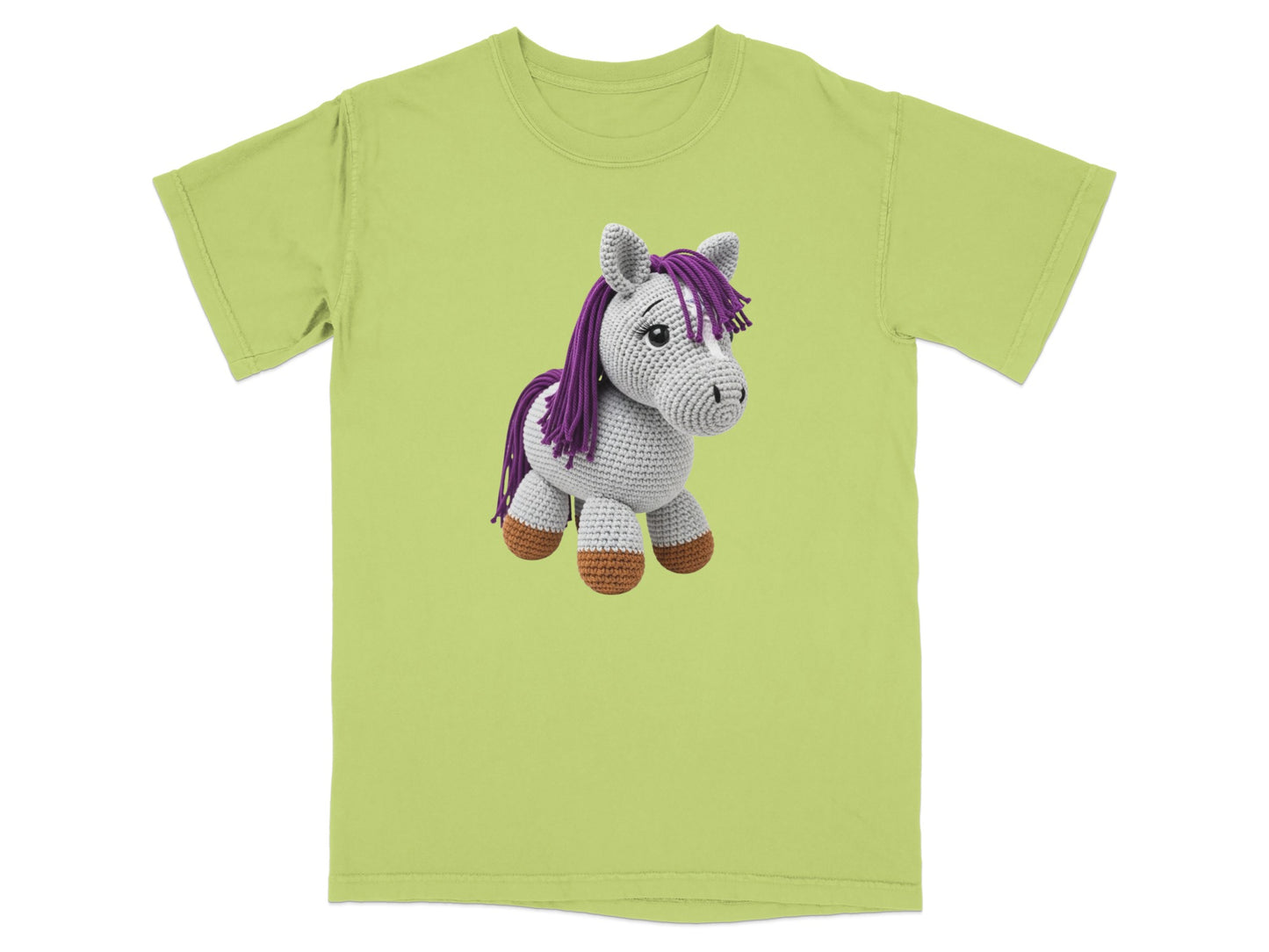 Green t-shirt featuring a crocheted unicorn with purple mane and tail.