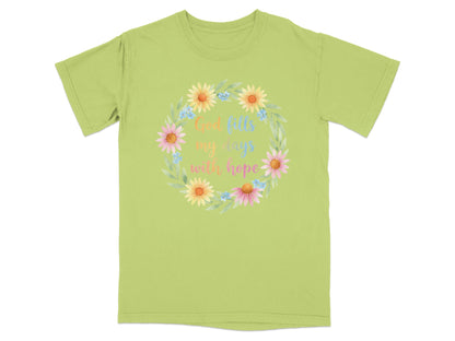 Green t-shirt with a floral wreath and text "God fills my days with hope".