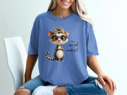T-shirt with cartoon opossum wearing sunglasses and bow, text "Your weird is wonderful".