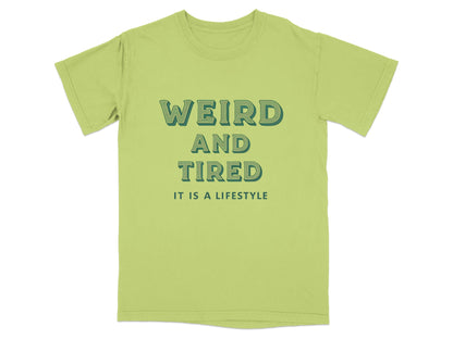 Light green t-shirt with "WEIRD AND TIRED IT IS A LIFESTYLE" text.