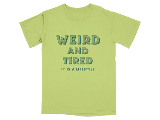 Light green t-shirt with "WEIRD AND TIRED IT IS A LIFESTYLE" text.
