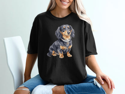 Black t-shirt with a watercolor illustration of a dachshund wearing a heart pendant.
